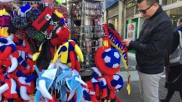 A man looks at football souvenirs at a stand in Santiago, on June 11, 2015 hours before the kick-off of the 2015 Copa America continental football tournament here in Chile.  AFP PHOTO / MARTIN BERNETTI