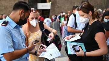 (FILES) In this file photo taken on August 6, 2021 visitors show their UE digital Covid-19 certificate for scanning before entering the Vatican Museums in the Vatican, as Italy made the Green Pass, which is an extension of the EU's digital Covid certificate, required from today to enter cinemas, museums and indoor sports venues, or eat indoors at restaurants. - Visitors from Asia and across the Atlantic were missing this summer 2021, but tourism in Europe picked up a little thanks to "local" visitors, with a special bonus for sunny destinations. (Photo by Andreas SOLARO / AFP)