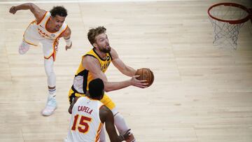 Indiana Pacers Domantas Sabonis, center, shoots against Atlanta Hawks' Trae Young, left, and Clint Capela, right, during the first half of an NBA basketball game on Sunday, April 18, 2021, in Atlanta. (AP Photo/Brynn Anderson)