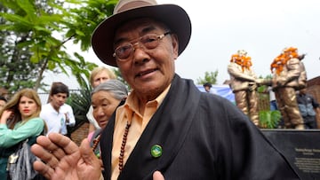 (FILES) Kancha Sherpa, a team member of the 1953 Mount Everest expedition that placed Tenzing Norgay and Edmund Hillary on the summit of the world's highest mountain, gestures after offering garlands over the statues of Tenzing Norgay and Edmund Hillary during the Mount Everest Diamond Jubilee celebrations in Kathmandu on May 29, 2013. The only surviving member of the first successful Everest expedition has died in Kathmandu on October 16 aged 92, his family said. Kanchha Sherpa was the last surviving member of the 1953 expedition that saw Edmund Hillary and Tenzing Norgay Sherpa become the first humans to summit the world's highest mountain. (Photo by Prakash MATHEMA / AFP)