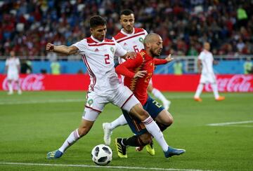 David Silva of Spain is challenged by Achraf Hakimi and Romain Saiss of Morocco during the 2018 FIFA World Cup Russia group B match.