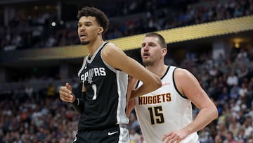 Victor Wembanyama #1 of the San Antonio Spurs is guarded by Nikola Jokic #15 of the Denver Nuggets in the fourth quarter at Ball Arena on January 03, 2025 in Denver, Colorado.