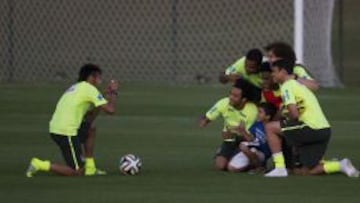 SONRISAS. Neymar hace una foto a varios compañeros con un pequeño aficionado en la última sesión antes de partir a Sao Paulo.