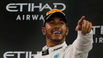 FILE PHOTO: Formula One F1 - Abu Dhabi Grand Prix - Yas Marina Circuit, Abu Dhabi, United Arab Emirates - December 1, 2019   Mercedes&#039; Lewis Hamilton celebrates with a trophy after winning the race    REUTERS/Hamad I Mohammed/File Photo