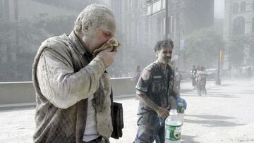 FILE &mdash; In this Sept. 11, 2001 file photo, a man coated with dust and debris from the collapse of the World Trade Center south tower coughs near City Hall, in New York. Two decades after the twin towers&#039; collapse, people are still coming forward to report illnesses that might be related to the attacks.(AP Photo/Amy Sancetta, File)