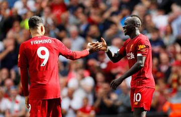 Danger men | Liverpool's Sadio Mane celebrates with Roberto Firmino.