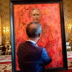Why is King Charles III’s portrait red? And why does he have a butterfly over his shoulder?