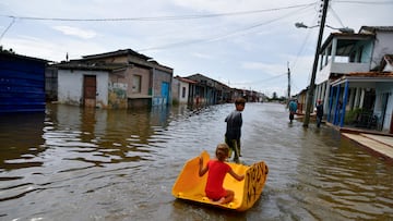 Children play on a flooded street as Hurricane Milton passes close to the Cuban coast, in Batabano, Cuba, October 9, 2024. REUTERS/Norlys Perez TPX IMAGES OF THE DAY