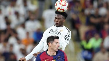 Real Madrid's French midfielder #14 Aurelien Tchouameni heads the ball past Barcelona's Polish forward #9 Robert Lewandowski during the Spanish Super Cup final football match between Real Madrid and Barcelona at the King Abdullah Sport City in Jeddah on January 12, 2025. (Photo by Haitham AL-SHUKAIRI / AFP)