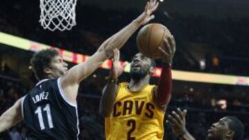 Mar 18, 2015; Cleveland, OH, USA; Cleveland Cavaliers guard Kyrie Irving (2) scores between Brooklyn Nets center Brook Lopez (11) and forward Thaddeus Young (30) during the first quarter at Quicken Loans Arena. Mandatory Credit: Ron Schwane-USA TODAY Sports