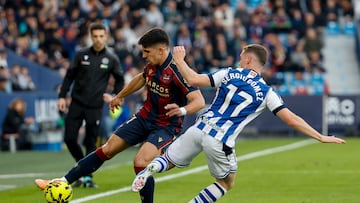 VALENCIA, 20/12/2025.- El defensa de la Real Sociedad Sergio Gómez (d) disputa un balón con el centrocampista del Levante Víctor García (i) durante el partido de LaLiga EA Sports entre Levante UD y Real Sociedad celebrado este sábado en el estadio Ciutat de València. EFE/ Ana Escobar