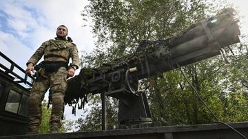 Ukrainian soldier with call-sign Ryba, which means "fish" in English, stands on the vehicle with a homemade four-tube multiple rocket launcher n Kryvyi Rih on September 28, 2022,  amid the Russian invasion of Ukraine. (Photo by Genya SAVILOV / AFP) (Photo by GENYA SAVILOV/AFP via Getty Images)