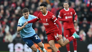 Liverpool's English defender #66 Trent Alexander-Arnold (C) vies with Brentford's German midfielder #27 Vitaly Janelt (L) during the English Premier League football match between Liverpool and Brentford at Anfield in Liverpool, north west England on November 12, 2023. (Photo by Paul ELLIS / AFP) / RESTRICTED TO EDITORIAL USE. No use with unauthorized audio, video, data, fixture lists, club/league logos or 'live' services. Online in-match use limited to 120 images. An additional 40 images may be used in extra time. No video emulation. Social media in-match use limited to 120 images. An additional 40 images may be used in extra time. No use in betting publications, games or single club/league/player publications. / 