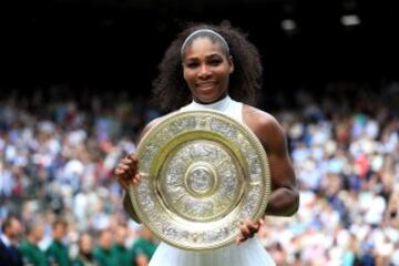 Serena Williams of The United States lifts the trophy following victory in The Ladies Singles Final against Angelique Kerber of Germany on day twelve of the Wimbledon Lawn Tennis Championships at the All England Lawn Tennis and Croquet Club on July 9, 201