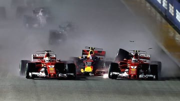 SINGAPORE - SEPTEMBER 17: Sebastian Vettel of Germany driving the (5) Scuderia Ferrari SF70H, Max Verstappen of the Netherlands driving the (33) Red Bull Racing Red Bull-TAG Heuer RB13 TAG Heuer and Kimi Raikkonen of Finland driving the (7) Scuderia Ferrari SF70H are caught up in a crash at the start during the Formula One Grand Prix of Singapore at Marina Bay Street Circuit on September 17, 2017 in Singapore.  (Photo by Lars Baron/Getty Images)