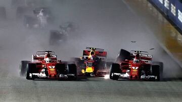 SINGAPORE - SEPTEMBER 17: Sebastian Vettel of Germany driving the (5) Scuderia Ferrari SF70H, Max Verstappen of the Netherlands driving the (33) Red Bull Racing Red Bull-TAG Heuer RB13 TAG Heuer and Kimi Raikkonen of Finland driving the (7) Scuderia Ferrari SF70H are caught up in a crash at the start during the Formula One Grand Prix of Singapore at Marina Bay Street Circuit on September 17, 2017 in Singapore. (Photo by Lars Baron/Getty Images)