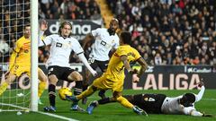 Valencia's Guinean defender #04 Mouctar Diakhaby tackles Barcelona's Brazilian forward #11 Raphinha (2L) during the Spanish league football match between Valencia CF and FC Barcelona at the Mestalla stadium in Valencia on December 16, 2023. (Photo by JOSE JORDAN / AFP)