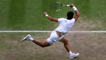 Spain's Carlos Alcaraz returns the ball to Denmark's Holger Rune during their men's singles quarter-finals tennis match on the tenth day of the 2023 Wimbledon Championships at The All England Lawn Tennis Club in Wimbledon, southwest London, on July 12, 2023. (Photo by Adrian DENNIS / AFP) / RESTRICTED TO EDITORIAL USE