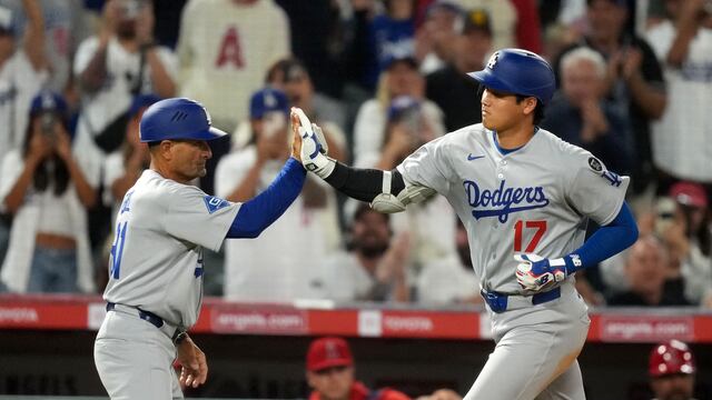 Aug 11, 2025; Anaheim, California, USA; Los Angeles Dodgers designated hitter Shohei Ohtani (17) celebrates with third base coach Dino Ebel (91 hitting a home run in the eighth inning against the Los Angeles Angels at Angel Stadium. Mandatory Credit: Kirby Lee-Imagn Images