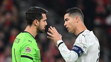 Portugal's forward #07 Cristiano Ronaldo (R) speaks with Portugal's goalkeeper 01 Diogo Costa prior to a penalty kick for Denmark during the UEFA Nations League quarter-final, first-leg football match Denmark v Portugal at the Parken Stadium in Copenhagen on March 20, 2025. (Photo by Jonathan NACKSTRAND / AFP)