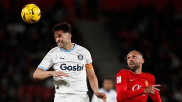 Girona's Spanish defender #15 Juanpe (L) wins a header against Real Mallorca�s Kosovar forward #07 Vedat Muriqi during the Spanish league football match between RCD Mallorca and Girona FC at the Mallorca Son Moix stadium in Palma de Mallorca on March 3, 2024. (Photo by JAIME REINA / AFP)