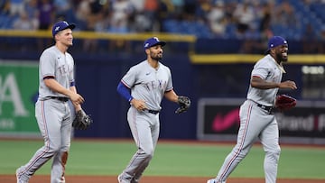 ST PETERSBURG, FLORIDA - OCTOBER 04: Corey Seager #5, Marcus Semien #2, and Adolis Garcia #53 of the Texas Rangers celebrate after defeating the Tampa Bay Rays 7-1in Game Two of the Wild Card Series at Tropicana Field on October 04, 2023 in St Petersburg, Florida.   Megan Briggs/Getty Images/AFP (Photo by Megan Briggs / GETTY IMAGES NORTH AMERICA / Getty Images via AFP)