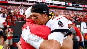 TAMPA, FL - JANUARY 1: Tom Brady #12 of the Tampa Bay Buccaneers hugs general manager Jason Licht after an NFL football game against the Carolina Panthers at Raymond James Stadium on January 1, 2023 in Tampa, Florida. (Photo by Kevin Sabitus/Getty Images)