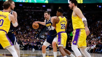 Denver Nuggets center Nikola Jokic (15) controls the ball against Los Angeles Lakers forward Rui Hachimura (28) as guard Luka Doncic (77) and guard Luke Kennard (10) and guard Christian Braun (0) defend in the first quarter at Ball Arena.
