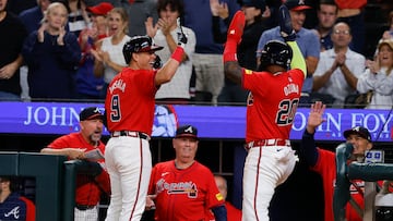 ATLANTA, GEORGIA - SEPTEMBER 27: Marcell Ozuna #20 of the Atlanta Braves reacts with Gio Urshela #9 after scoring during the eighth inning against the Kansas City Royals at Truist Park on September 27, 2024 in Atlanta, Georgia. Todd Kirkland/Getty Images/AFP (Photo by Todd Kirkland / GETTY IMAGES NORTH AMERICA / Getty Images via AFP)