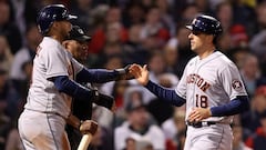 BOSTON, MASSACHUSETTS - OCTOBER 19: Jason Castro #18 is congratulated by Yuli Gurriel #10 of the Houston Astros after Castro scored in the ninth inning against the Boston Red Sox in Game Four of the American League Championship Series at Fenway Park on Oc