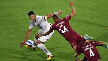 Brazil's Atletico Mineiro Hulk (L) and Colombia's Deportes Tolima Juan Rios vie for the ball during the Copa Libertadores group stage first leg football match at the Manuel Murillo Toro stadium in Ibague, Tolima department, Colombia, on April 6, 2022. (Photo by Daniel Munoz / AFP)