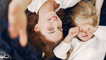 Family in a summer park. Mother in a white dress. Cute little girl
