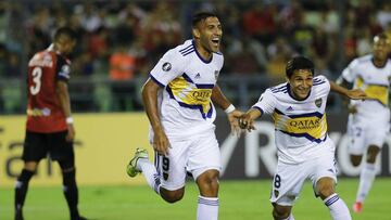 Ramon Abila of Argentina's Boca Juniors, left, celebrates with teammate Javier Obando scoring the opening goal during a Copa Libertadores Group H soccer match against Venezuela's Caracas FC in Caracas, Venezuela, Tuesday, March 3, 2020. (AP Phot