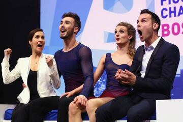 The winners celebrate their score in the Free Dance Program with coaches Marie-France Dubreuil, left, and Romain Haguenauer,