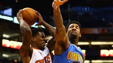 Nov 27, 2016; Phoenix, AZ, USA; Phoenix Suns guard Eric Bledsoe (left) grabs a rebound against Denver Nuggets forward Wilson Chandler in the fourth quarter at Talking Stick Resort Arena. The Nuggets defeated the Suns 118-114. Mandatory Credit: Mark J. Rebilas-USA TODAY Sports
