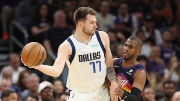 Luka Doncic of the Dallas Mavericks handles the ball against Chris Paul of the Phoenix Suns during the first half of Game Seven of the Western Conference Second Round NBA Playoffs at Footprint Center.