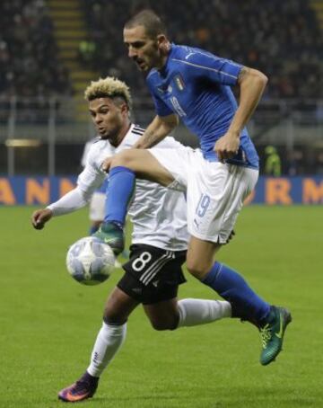 Italy's Leonardo Bonucci challenges for the ball with Germany's Serge Gnabry during the international friendly soccer match between Italy and Germany at the San Siro stadium in Milan, Italy, Tuesday, Nov. 15, 2016. (AP Photo/Antonio Calanni)
