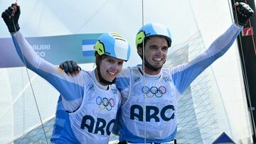 Silver medallists Argentina's Mateo Majdalani celebrate after the medal race of the mixed Nacra 17 multihull event during the Paris 2024 Olympic Games sailing competition at the Roucas-Blanc Marina in Marseille on August 8, 2024. (Photo by Christophe SIMON / AFP)