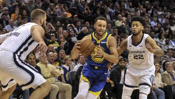 Mar 27, 2019; Memphis, TN, USA; Golden State Warriors guard Stephen Curry (30) controls the ball between Memphis Grizzlies forward Chandler Parsons (25) and Grizzlies guard Tyler Dorsey (22) during the second half at FedExForum. Mandatory Credit: Justin Ford-USA TODAY Sports