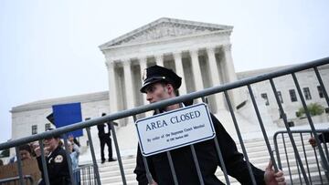 US Supreme Court Police officers set up barricades on the sidewalk as demonstrators gather in front of the US Supreme Court.