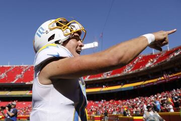 KANSAS CITY, MISSOURI - SEPTEMBER 26: Justin Herbert #10 of the Los Angeles Chargers celebrates after defeating the Kansas City Chiefs 30-24 at Arrowhead Stadium on September 26, 2021 in Kansas City, Missouri.