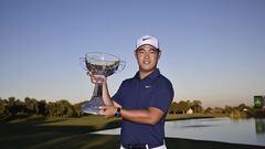 Tom Kim of South Korea poses with the trophy
