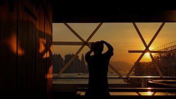 A shop worker tapes a glass window in preparation for Typhoon Ragasa at a store in Hong Kong, China, September 22, 2025. REUTERS/Tyrone Siu