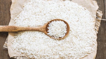 Basmati rice with a spoon on an dark wood
