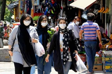 Iranian women wearing protective gear amid the Covid-19 pandemic shop at the Tajrish Bazaar market in the capital Tehran on July 14, 2020.