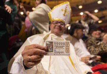 Un hombre disfrazado de papa con su dcimo antes de comenzar la celebracin del Sorteo Extraordinario de la Lotera de Navidad 2024, en el Teatro Real, a 22 de diciembre de 2024.