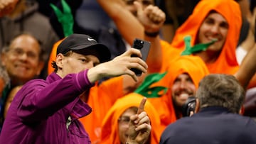 Italy's Jannik Sinner takes a selfie with his orange-clad fans "Carota Boys" after he defeated Russia's Daniil Medvedev in the men's quarterfinals match on day ten of the US Open tennis tournament at the USTA Billie Jean King National Tennis Center in New York City, on September 4, 2024. (Photo by Kena Betancur / AFP)