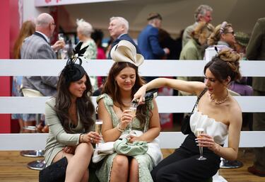 Racegoers attend the second day of the Grand National Festival horse race meeting at Aintree Racecourse in Liverpool, north-west England, on April 12, 2024. (Photo by Oli SCARFF / AFP)