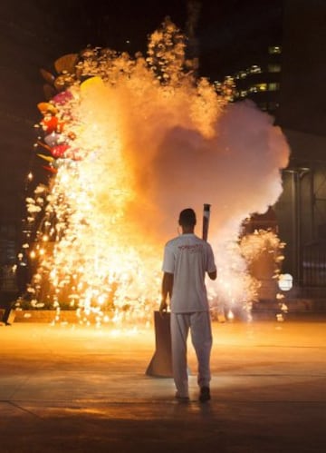 Torch bearer Steve Nash lights the cauldron to officially launch the 2015 Pan American Games in Toronto, Ontario on  July 10, 2015. AFP PHOTO/ KEVIN VAN PAASSEN