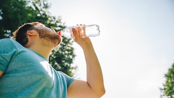 man drinking water in hot summer day. copy space